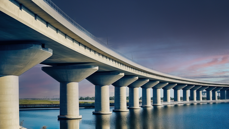 Concrete Bridge over a waterway with a looming storm behind it